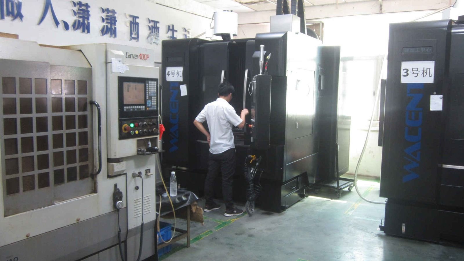 Technician operating a vertical CNC machining centre at Kingtop