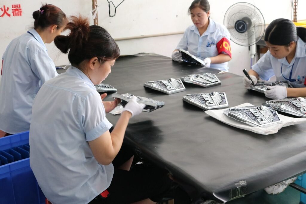 Quality control staff inspecting zinc alloy wine stoppers piece by piece on the factory inspection line