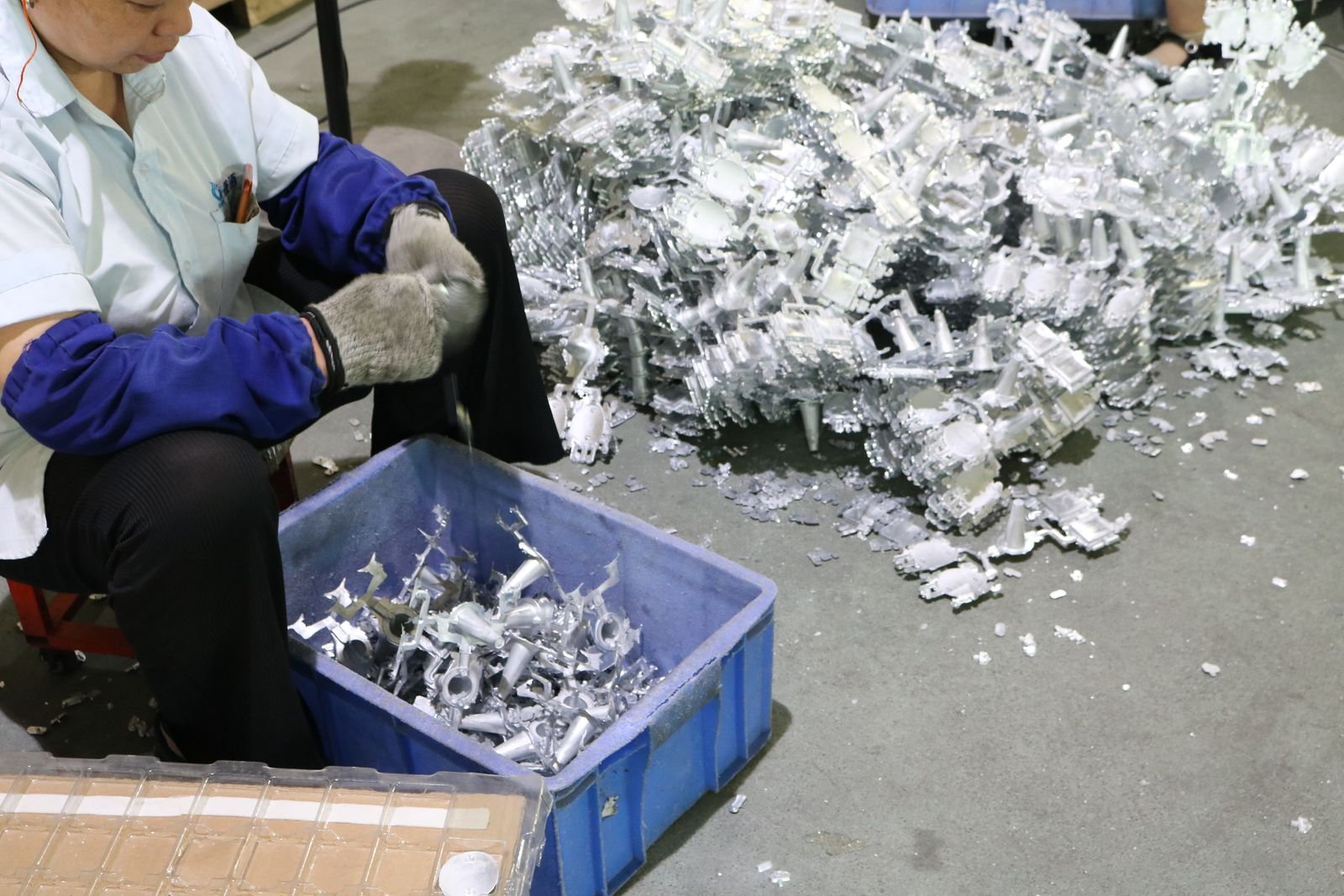 Zinc alloy raw material and cast metal gift parts sorted on the workshop floor