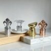 Custom metal wine stoppers displayed on wood risers for retail presentation