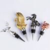 Assorted gold plated animal wine stoppers with detailed sculpting